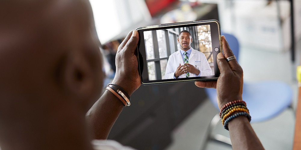 Man on teleheath call with physician Man on teleheath call with physician